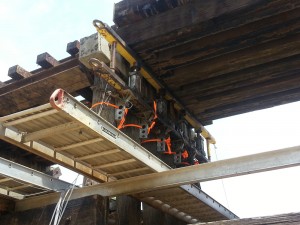 Hydraulic jack installed on railway bridge.